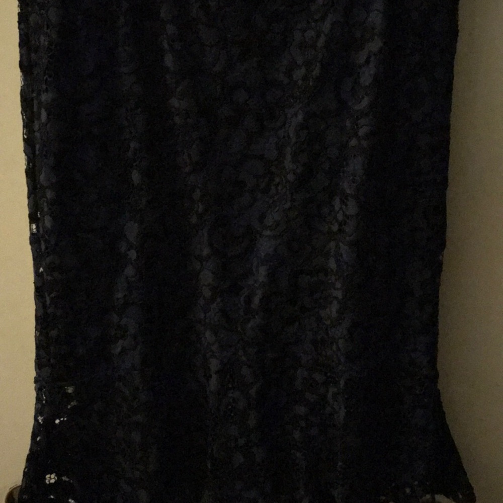 Black overlay of navy blue lining skirt.